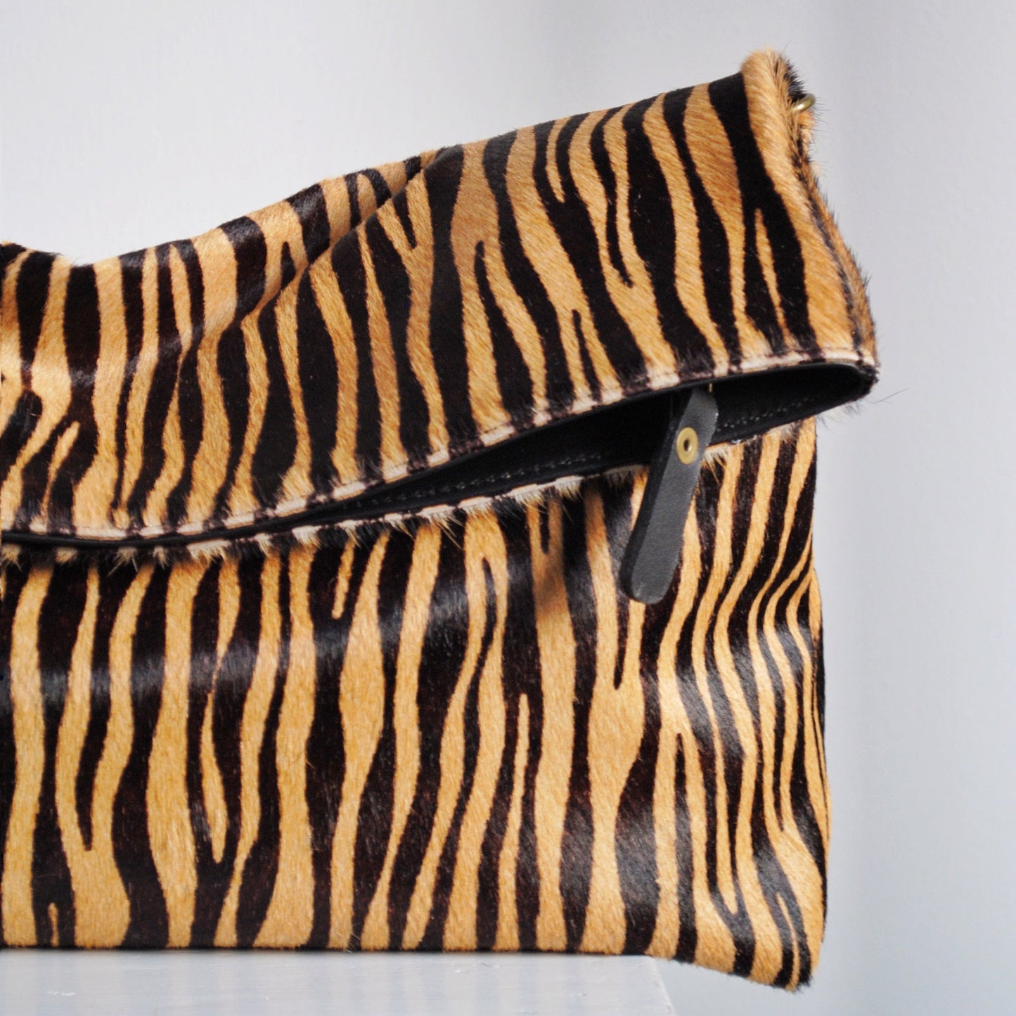 Clutch Tana Pelo Print